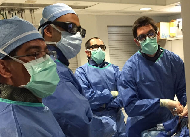 From left, Drs. John Racadio, Seetharam Chadalavada, and Matt Smetts observe Dr. Sinisa Haberle perform a simulated complex inferior vena cava (IVC) filter removal procedure.