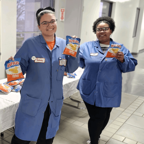 Employees distributing snacks for a Black History Month celebration